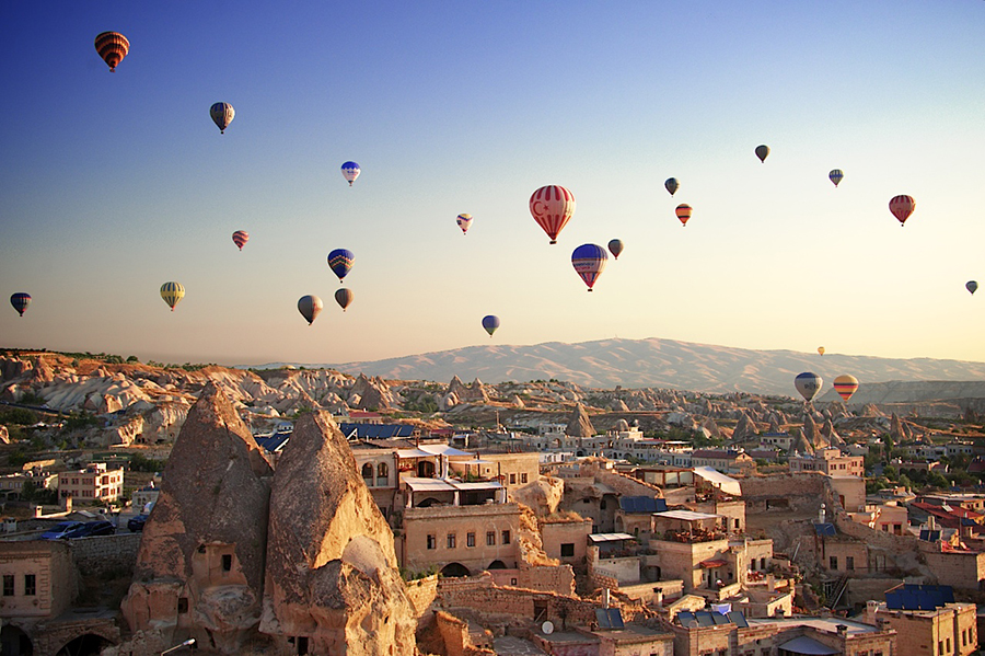 Sunrise in Cappadocia, Turkey, with balloons and typical fairy chimney